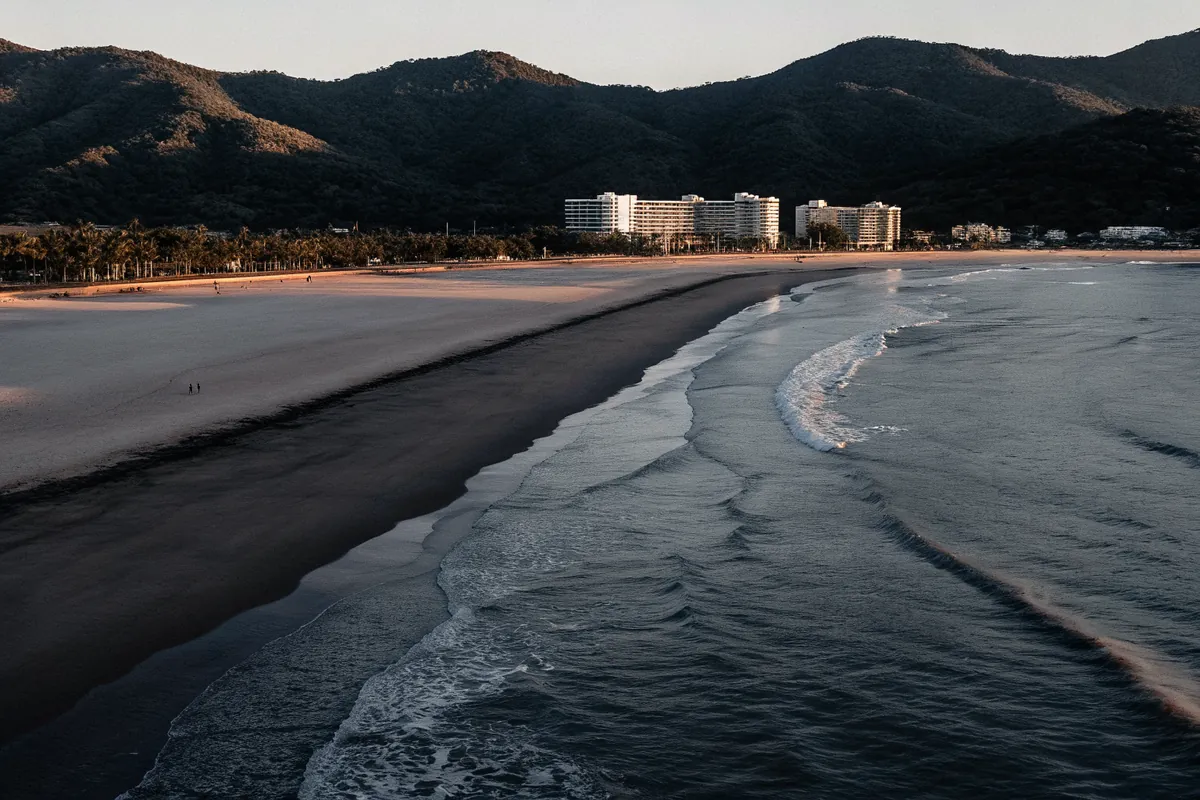 A long beach below green mountains in Da Nang