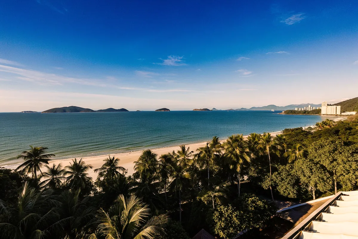 Nha Trang bay with islands on the horizon and palm trees along the beach